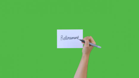 Woman-Writing-Retirement-In-Cursive-on-Paper-with-Green-Screen